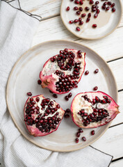 Fresh Opened Pomegranate on Light Colored Plate