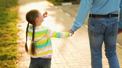 father with little child park, happy family, dad holding little child hand, parental care kid,...