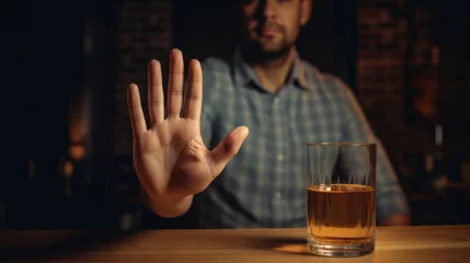 Foto op Plexiglas man refuses say no and avoid to drink an alcohol whiskey , stopping hand sign male, alcoholism treatment, alcohol addiction, quit booze, Stop Drinking Alcohol. Refuse Glass liquor, unhealthy, reject © pinkrabbit