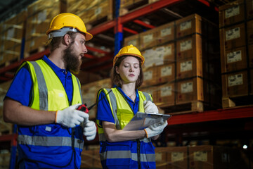 workers checking and inspecting metal machine part items for shipping. male and woman checking the...