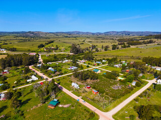 Aerial image of a small rural town with dirt streets and small houses