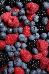 Assortment of fresh ripe berries as background, top view