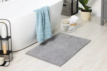 Foto op Plexiglas Soft light grey mat near tub in bathroom © New Africa