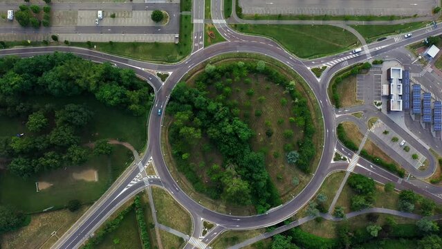 Roundabout zoom in: roundabout light traffic of cars and trucks on the circle ring road aerial top view