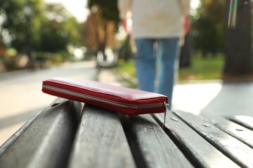 Woman lost her purse on wooden surface outdoors, selective focus. Space for text - obrazy, fototapety, plakaty