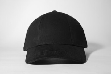 Stylish black baseball cap on white background