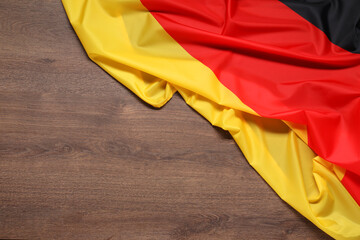 Flag of Germany on wooden background, top view. Space for text