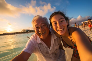 grandfather and granddaughters having a good time on beach at sunset, Okinawa, Japan - obrazy, fototapety, plakaty