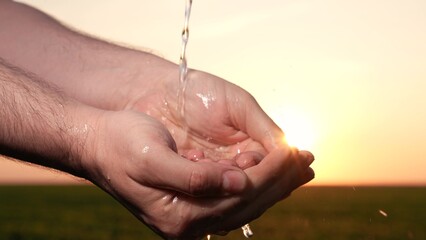 man washes hands sunset, taking care hygiene cleanliness. people strive ensure purity protection....