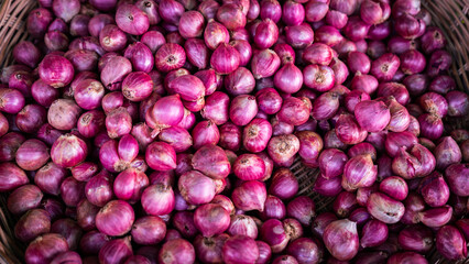Red onions at the traditional market in basket. Purple Onions. Fresh purple onions as a background.