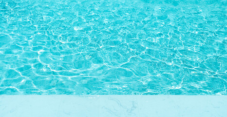 Background of water in swimming pool with copy space on white marble. surface of blue swimming pool.