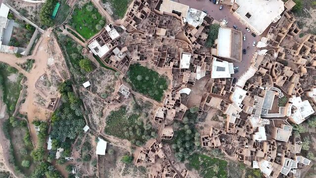 Aerial birdseye circling and rising over Ushaiger Heritage Village, Saudi Arabia