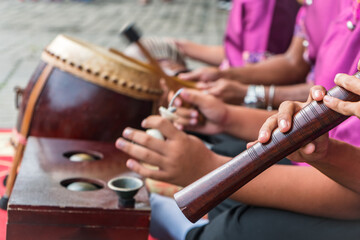 Boys playing Thai musical instrument close up on oboe. "Pi Nai" called in Thai.