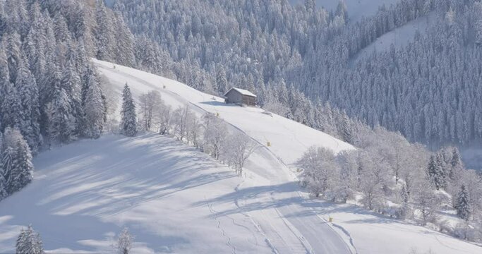 Small hut next to a ski slope in Austria covered with snow