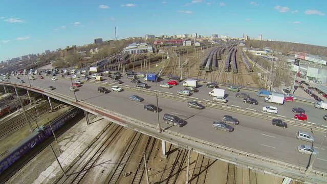 Traffic on Rizhskaya flyover and railway with trains
