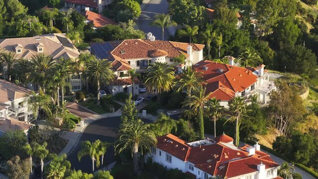 Drone shot of houses roofs of Calabasas expensive property, Los Angeles suburban, USA. Overhead view of Calabasas Park estate surrounded green mountains. Suburban community of Calabasas, 4k footage