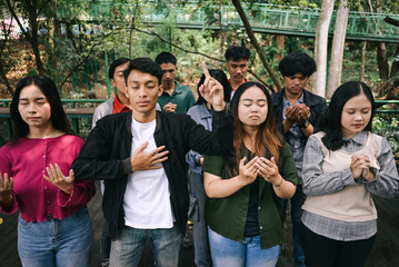 Group of young multiethnic people praying together
