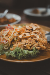Crispy catfish salad with green mango sauce spicy. Famous appetizer menu in Thai restaurant.