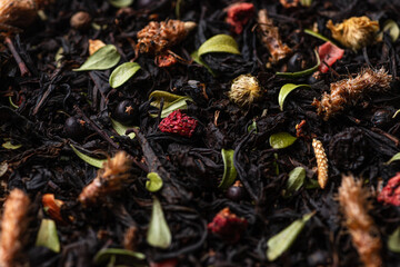 Macrophotography of tea with dried leaves and berries