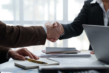 Businessmen shake hands to end the meeting. Successful negotiations and handshakes Group of...