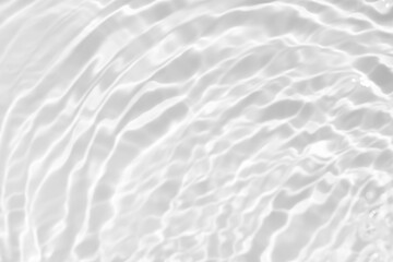 White water with ripples on the surface. Defocus blurred transparent white colored clear calm water surface texture with splashes and bubbles. Water waves with shining pattern texture background.