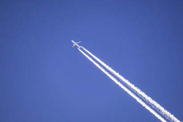 A jetliner flies in the sky on a winter day