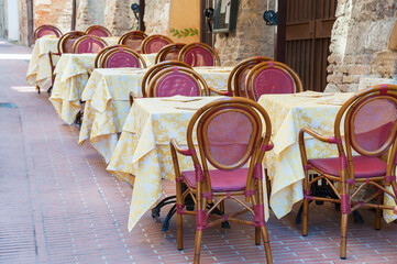 Nice and cosy sidewalk cafe in resort town San Gimignano, Tuscany, Italy