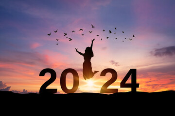 Young woman enjoying and celebrating New Year 2024 with the beautiful sunrise sky and landscape - 695184271
