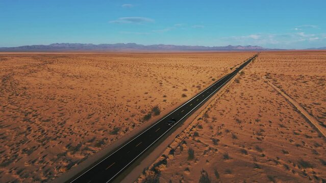 Modern car driving in the desert on a street from California to Arizona. Scenic sunset landscape.