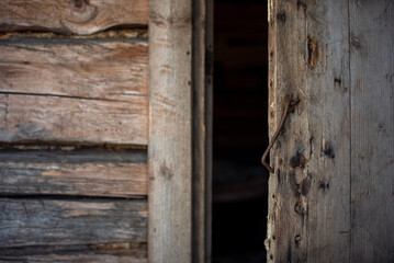 The open door of an old abandoned cabin