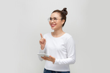 Young woman with calculator and raised index finger on white background