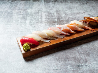 Various sushi on wooden tray