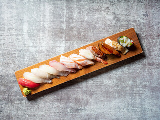 Various sushi on wooden tray