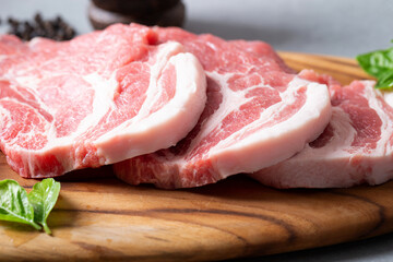 Fresh pork neck on wooden cutting board