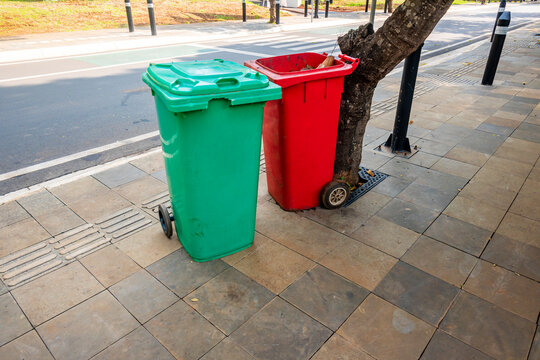 Green and red garbage bins