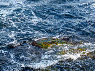 Sea with waves and rocks on the shore