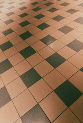 Brown tiled floor in a room as an abstract background. Texture