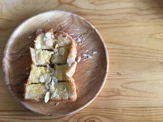 Buttered bread on a wooden plate