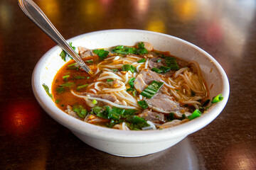 Spicy Vietnamese soup with succulent slices of beef and rice noodles, vegetables and broth
