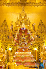  The main shrine of Wat Pak Nam Jolo features a stunning golden Buddha seated on a naga throne,...