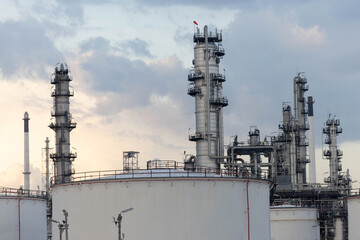 Oil and gas industrial refinery at twilight, Oil refinery and Petrochemical plant pipeline steel, Refinery factory oil storage tank and pipeline steel at twilight.