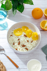 cottage cheese in a bowl with orange and nuts