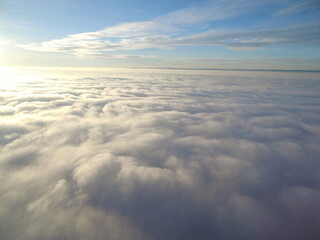 Fototapeta na wymiar flight above clouds through the cloudy sky