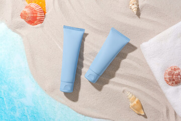 Set against a fresh sea background with sand, starfish, seashells, white towel and two vibrant blue...
