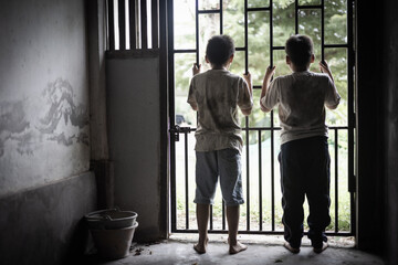 Children who were imprisoned in a room with a steel cage. The concept of stopping violence against children and human trafficking.