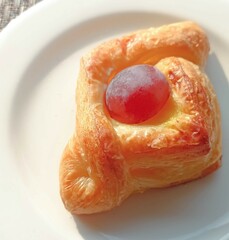 pastry with grape decoration on plate 