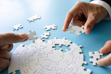  Hand put the last piece of jigsaw puzzle to complete the mission, Business solutions, success and...