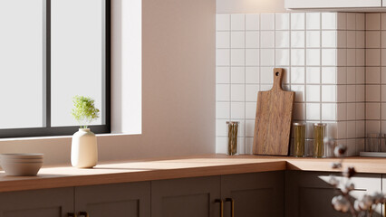 A bright beige-toned kitchen interior with sunlight 
coming through the window.