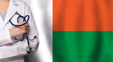 Madagascan medicine and healthcare concept. Doctor close up against flag of Madagascar background