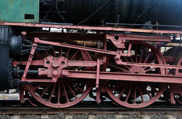 Fototapeta na wymiar Transmission system of an old train. Traction wheels of a steam train